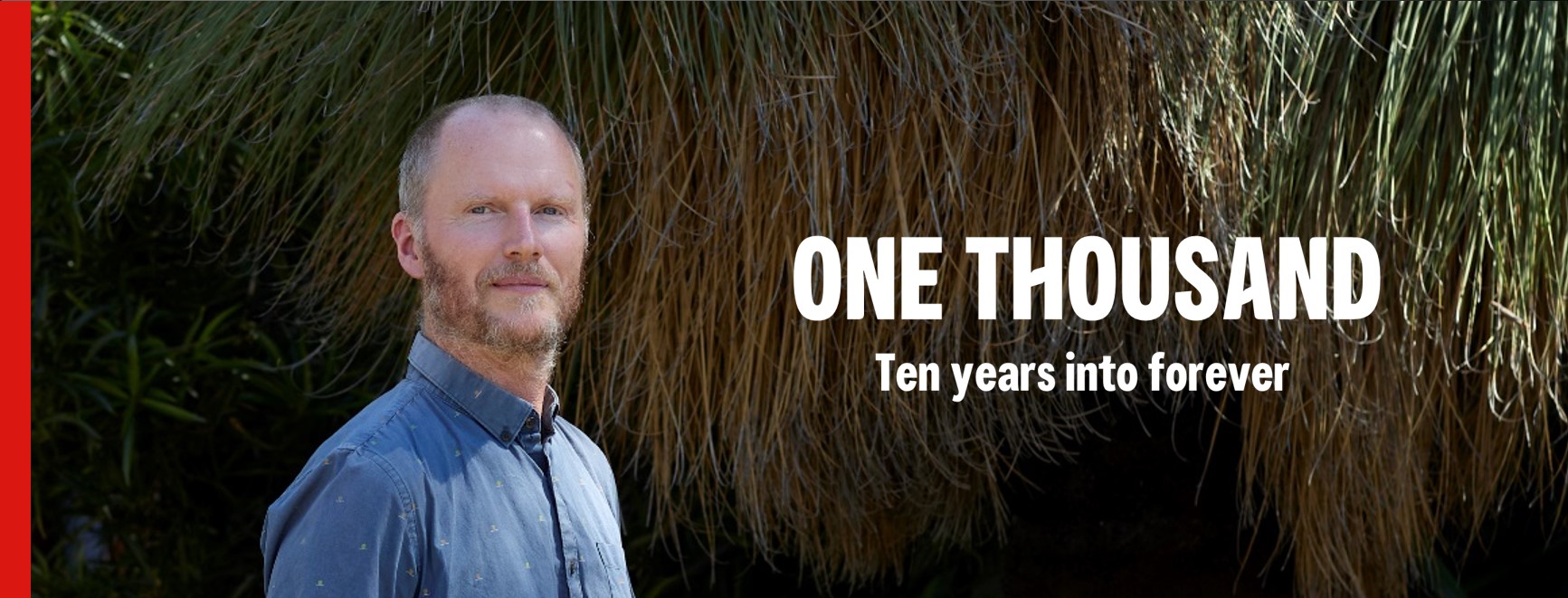 Image of Hamish Clarke with magazine title: "One Thousand, Ten years into Forever" written across it. 